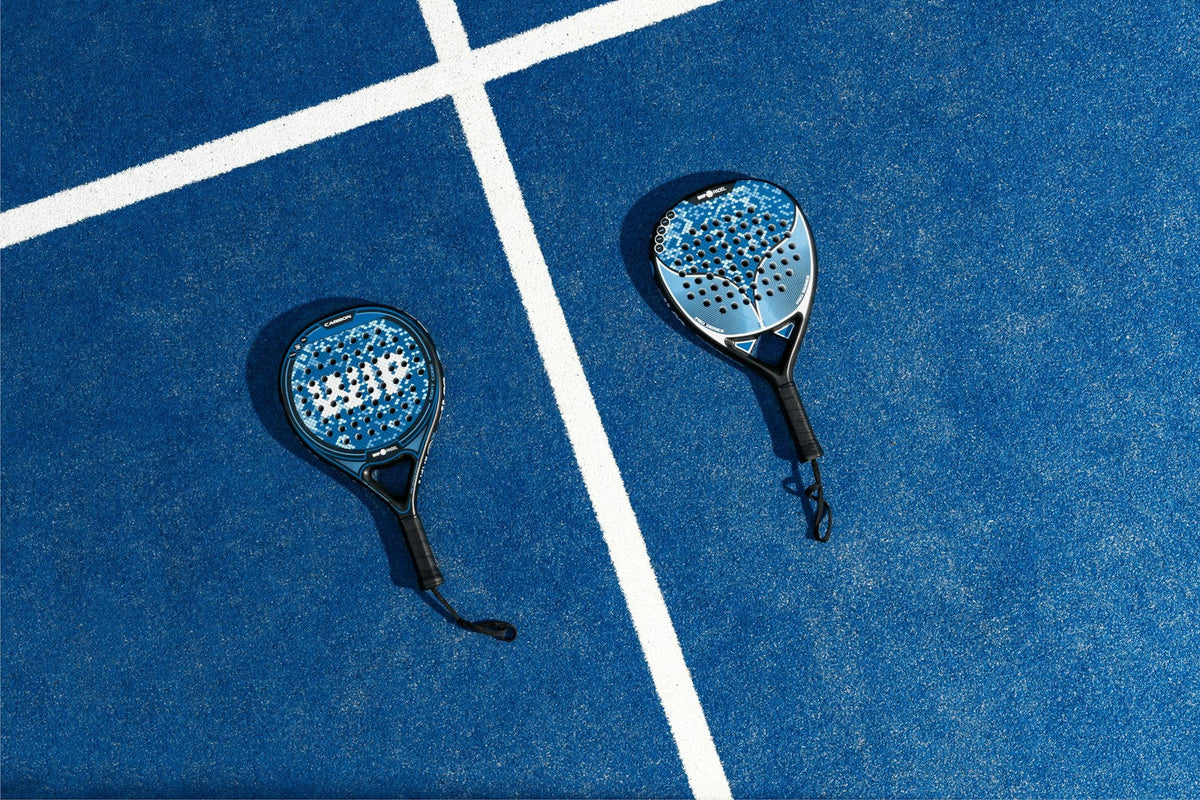 Dos palas de pádel sobre la pista